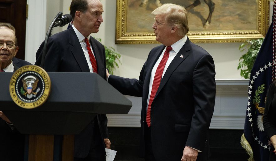 President Donald Trump congratulates David Malpass, under secretary of the Treasury for international affairs, after announcing his nomination to head the World Bank, during an event in the Rosevelt Room of the White House, Wednesday, Feb. 6, 2019, in Washington. (AP Photo/ Evan Vucci)