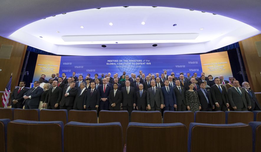 Secretary of State Mike Pompeo, front row center, and other foreign ministers pose for a family photo during the Global Coalition to Defeat ISIS meeting, at the State Department, Wednesday, Feb. 6, 2019, in Washington. (AP Photo/Alex Brandon)