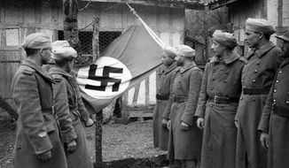 Displaying a Nazi flag seized in combat at the Western Front, these French North African soldiers look over their prize after the encounter on April 4, 1940. (AP Photo)