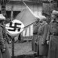 Displaying a Nazi flag seized in combat at the Western Front, these French North African soldiers look over their prize after the encounter on April 4, 1940. (AP Photo)