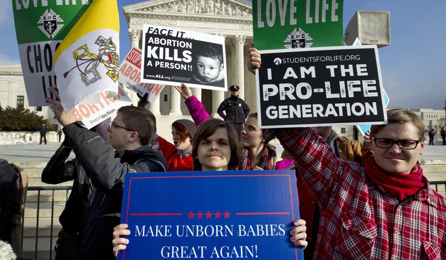 In this Friday, Jan. 18, 2019, file photo, anti-abortion activists protest outside of the U.S. Supreme Court, during the March for Life in Washington. (AP Photo/Jose Luis Magana) ** FILE **