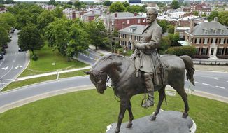 FILE - This June 27, 2017 file photo shows the statue of Confederate General Robert E. Lee in the middle of a traffic circle on Monument Avenue in Richmond, Va. Statues of Confederate generals and other symbols of Richmond&#39;s once-booming slave trade stand as painful reminders of the city&#39;s turbulent racial past. (AP Photo/Steve Helber)