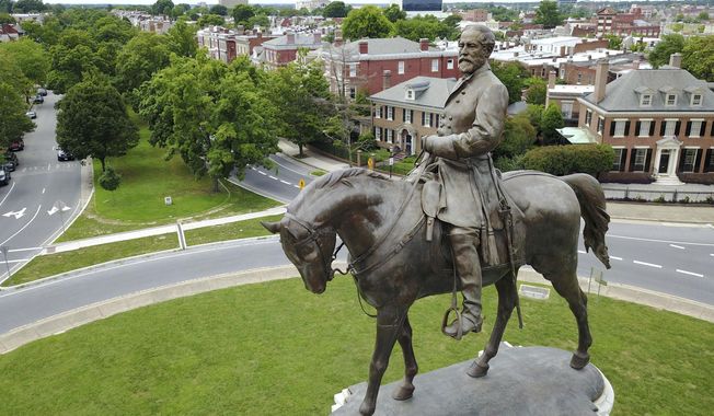 FILE - This June 27, 2017 file photo shows the statue of Confederate General Robert E. Lee in the middle of a traffic circle on Monument Avenue in Richmond, Va. Statues of Confederate generals and other symbols of Richmond&#x27;s once-booming slave trade stand as painful reminders of the city&#x27;s turbulent racial past. (AP Photo/Steve Helber)