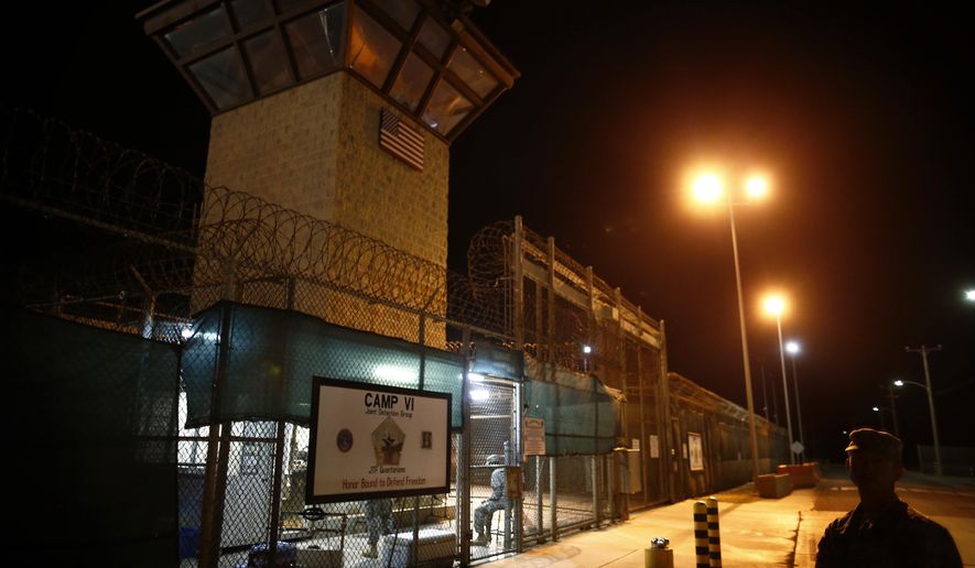 FILE - In this Nov. 20, 2013 file photo, reviewed by the U.S. military, the entrance to Camp VI detention facility is guarded at Guantanamo Bay Naval Base, Cuba. The Guantanamo Bay detention center would receive its first new prisoners in more than a decade under one option being considered as the U.S. withdraws its forces from Syria and works to resolve the fate of hundreds of captured suspected Islamic State fighters, officials say.(AP Photo/Charles Dharapak, File)