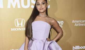 FILE - In this Dec. 6, 2018 file photo, Ariana Grande attends the 13th annual Billboard Women in Music event in New York. Grammys producer Ken Ehrlich says the show had multiple conversations with Grande about performing at the awards show on Sunday but the singer “felt it was too late for her to pull something together.” (Photo by Evan Agostini/Invision/AP, File)
