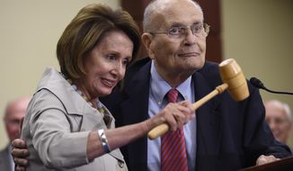 FILE - In this July 29, 2015 file photo, House Minority Leader Nancy Pelosi of Calif., standing with former Rep. John Dingell, D-Mich., holds up the gavel Dingell used 50 years ago when Medicare legislation was passed during an event marking the 50th Anniversary of Medicare and Medicaid on Capitol Hill in Washington. Dingell, the longest-serving member of Congress in American history who mastered legislative deal-making and was fiercely protective of Detroit&#39;s auto industry, has died at age 92. Dingell, who served in the U.S. House for 59 years before retiring in 2014, died Thursday, Feb. 7, 2019, at his home in Dearborn, said his wife, Congresswoman Debbie Dingell. (AP Photo/Susan Walsh, File)