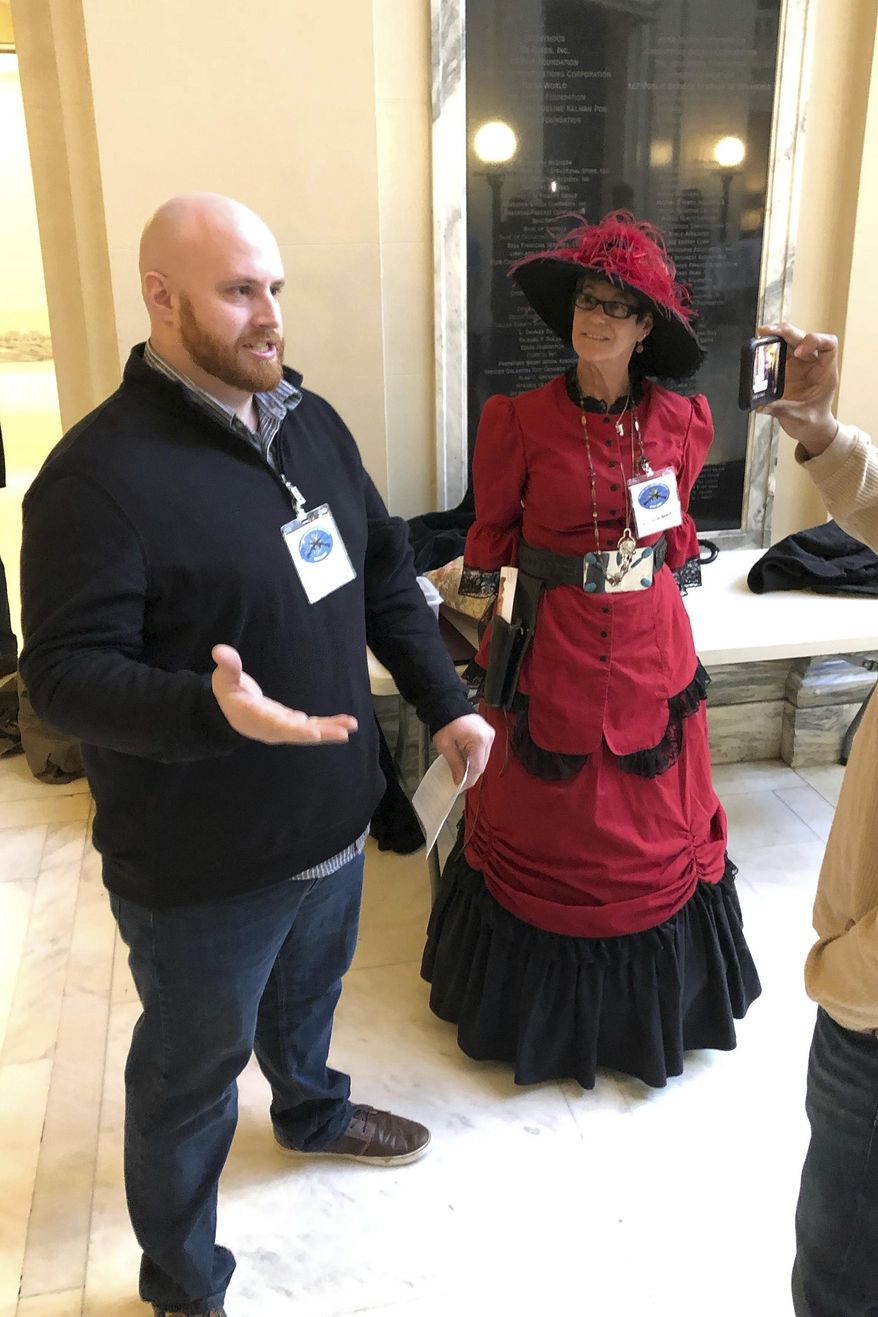 Members of a pro-gun group Alex Kearns and Belinda Barker talk to a reporter, Thursday, Feb. 7, 2019, in Oklahoma City, after a House panel approved a bill that would allow Oklahomans to carry firearms without a permit, training or background check. (AP Photo/Sean Murphy)