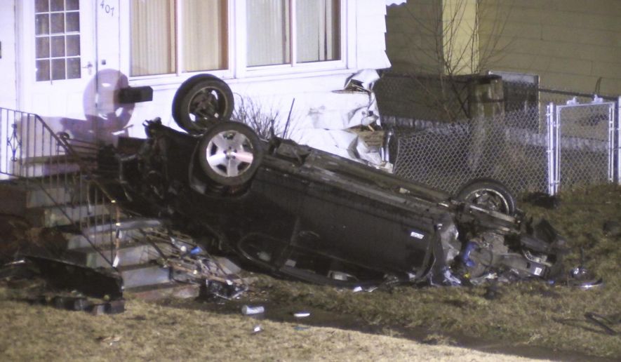 A vehicle remains on the porch of a home after a police chase turned deadly Wednesday, Feb. 6, 2019 in Hammond, Ind. Authorities say a man has died after speeding away from police and crashing into a home. The Lake County coroner's office identified the driver as 25-year-old Antonio Short. Indiana State Police are investigating the crash. (John J. Watkins/The Times via AP)