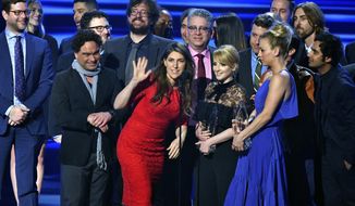 FILE - In this Jan. 18, 2017 file photo, the cast and crew of &amp;quot;The Big Bang Theory&amp;quot; accept the award for favorite network TV comedy at the People&#39;s Choice Awards at the Microsoft Theater in Los Angeles. Champagne is briefly replacing scripts on the set of &amp;quot;The Big Bang Theory.&amp;quot; A nondescript building on the sprawling Warner Brothers production lot in Burbank known as Stage 25 was renamed Thursday, Feb. 7, 2019, for the CBS sitcom that called it home for 12 years and will soon depart. (Photo by Vince Bucci/Invision/AP, File)