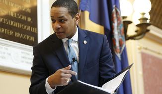 Virginia Lt. Gov Justin Fairfax looks over a briefing book prior to the start of the senate session at the Capitol in Richmond, Va., Thursday, Feb. 7, 2019. A California woman has accused Fairfax of sexually assaulting her 15 years ago. (AP Photo/Steve Helber)