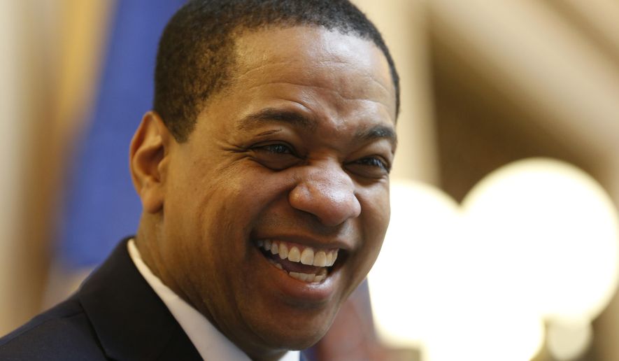 Virginia Lt. Gov Justin Fairfax smiles during the senate session at the Capitol in Richmond, Va., Thursday, Feb. 7, 2019. A California woman has accused Fairfax of sexually assaulting her 15 years ago. (AP Photo/Steve Helber)