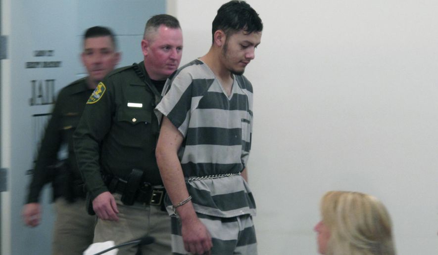 Wilber Martinez-Guzman is escorted into Carson City Justice Court on Friday, Feb. 8, 2019, before his preliminary hearing was postponed on multiple counts stemming from his alleged murder of four people in northern Nevada last month. The 20-year-old Salvadoran immigrant waived his right to speedy proceedings in Carson City on burglary charges related to items stolen from some of the victims. Prosecutors say he's expected to be extradited to Reno next week to face four murder counts first. (AP Photo/Scott Sonner)