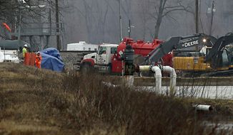Excavation equipment is used to search for an oil leak close to where the TransCanada Corp&#39;s Keystone oil pipeline runs through northern St. Charles County off of Highway C, Thursday, Feb. 7, 2019, near St. Charles, Mo. The source of the oil leak has not yet been identified but the Keystone oil pipeline has been shut and the Missouri Department of Natural Resources official said the the release is stopped. (David Carson/St. Louis Post-Dispatch via AP)