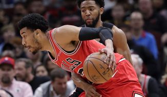 Chicago Bulls forward Otto Porter Jr., left, drives against Washington Wizards guard Chasson Randle during the first half of an NBA basketball game Saturday, Feb. 9, 2019, in Chicago. (AP Photo/Nam Y. Huh)