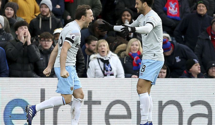 West Ham United's Mark Noble, left, celebrates scoring his side's first goal of the game against Crystal Palace, with team-mate Felipe Anderson during their English Premier League soccer match at Selhurst Park in London, Saturday Feb. 9, 2019. (Paul Harding/PA via AP)