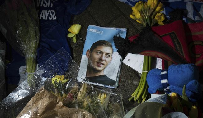 Tributes are placed outside the Cardiff City Stadium, Wales, for Emiliano Sala, Friday Feb. 8, 2019. Tributes are being paid across soccer to Argentine player Emiliano Sala, with the French league announcing a minute&#x27;s applause before matches. French club Nantes says it will retire the No. 9 jersey worn by Sala before he was sold last month to Cardiff in the English Premier League. (Aaron Chown/PA via AP)