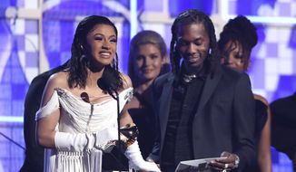 Cardi B, left, accepts the award for best rap album for &amp;quot;Invasion of Privacy&amp;quot; as Offset looks on at the 61st annual Grammy Awards on Sunday, Feb. 10, 2019, in Los Angeles. (Photo by Matt Sayles/Invision/AP)