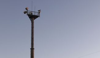In this Tuesday, Nov. 15, 2016, photo, a U.S. Customs and Border Patrol passes a Remote Surveillance Camera Systems tower stationed along a section of border in Brownsville, Texas. Since tower-mounted Border Patrol video surveillance cameras began going up in 1999 in the Brownsville area, illegal cross-border &quot;traffic dried up by 85-90 percent,&quot; said Johnny Meadors, the sector&#39;s assistant chief for technology. (AP Photo/Eric Gay)