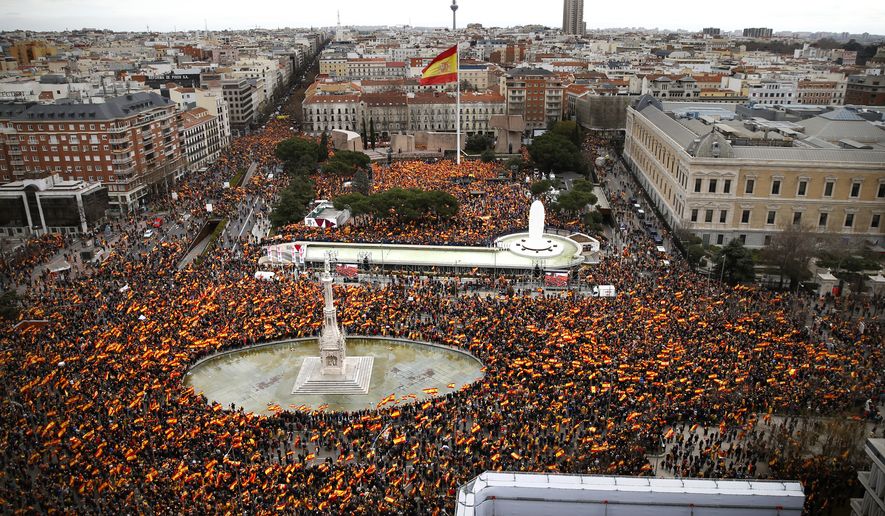 Thousands of demonstrators hold Spanish flags during a protest in Madrid, Spain, on Sunday, Feb.10, 2019. Thousands of Spaniards in Madrid are joining a rally called by right-wing political parties to demand that Socialist Prime Minister Pedro Sanchez step down. (AP Photo/Andrea Comas)