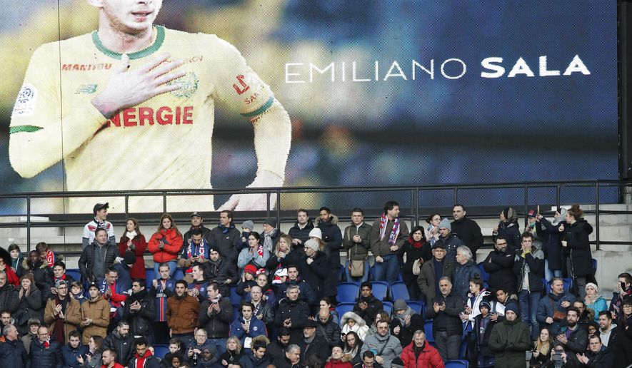 Tributes are paid to Emiliano Sala ahead of the French League One soccer match between Paris Saint-Germain and Bordeaux at the Parc des Princes stadium in Paris, Saturday, Feb. 9, 2019. (AP Photo/Christophe Ena)