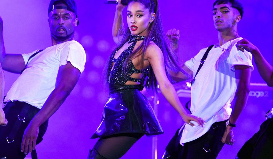 FILE - In this June 2, 2018 file photo, Ariana Grande, center, performs at Wango Tango in Los Angeles. Grande won her first Grammy Award on Sunday, Feb. 10, but the singer didn’t collect it after she decided to skip the ceremony following a public dispute with the show’s producer. She won best pop vocal album for “Sweetener,” beating Taylor Swift, Kelly Clarkson, Pink, Shawn Mendes and Camila Cabello in the category. Grande was not in attendance at the pre-telecast ceremony, but she wrote on Twitter that her win was “wild and beautiful.” (Photo by Chris Pizzello/Invision/AP, File)