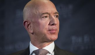 n this Sept. 13, 2018, file photo Jeff Bezos, Amazon founder and CEO, speaks at The Economic Club of Washington&#39;s Milestone Celebration in Washington. An attorney for the head of the National Enquirer’s parent company says the tabloid didn’t commit extortion or blackmail by threatening to publish Bezos’ explicit photos. Elkan Abramowitz represents American Media Inc. CEO David Pecker. He defended the tabloid’s practice as a “negotiation” in an interview Sunday, with ABC News.(AP Photo/Cliff Owen, File)