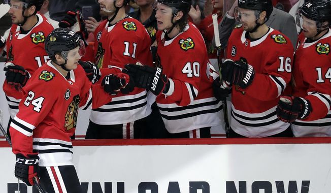 Chicago Blackhawks center Dominik Kahun (24) celebrates with teammates after scoring a goal during the first period of an NHL hockey game against the Detroit Red Wings, Sunday, Feb. 10, 2019, in Chicago. (AP Photo/Nam Y. Huh)