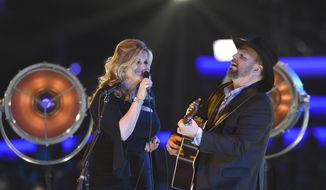 Trisha Yearwood, left, and Garth Brooks perform &amp;quot;Old Flames Can&#39;t Hold a Candle To You&amp;quot; at MusiCares Person of the Year honoring Dolly Parton on Friday, Feb. 8, 2018, at the Los Angeles Convention Center. (Photo by Chris Pizzello/Invision/AP)