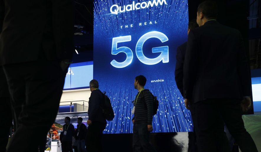 In this Jan. 9, 2019, file photo a sign advertises 5G at the Qualcomm booth at CES International in Las Vegas. 5G is a new technical standard for wireless networks that promises faster speeds; less lag, or latency, when connecting to the network; and the ability to connect many devices to the internet without bogging it down. (AP Photo/John Locher, File)