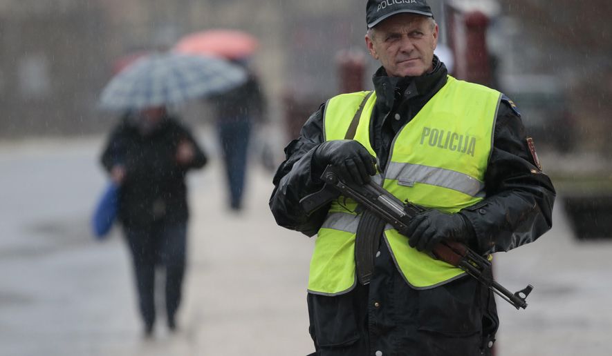 Bosnian police secure an area during police action in Bradina, Bosnia, Monday, Feb. 11, 2019. Police in Bosnia say they have launched a manhunt for a suspect in the killings of two people in the past week which is reported to have triggered some panic in the country. (AP Photo/Amel Emric)