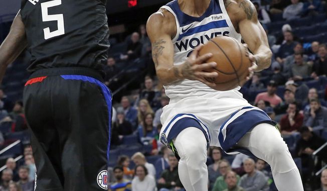 Minnesota Timberwolves&#x27; Derrick Rose, right, eyes the basket on a layup as Los Angeles Clippers&#x27; Montrezl Harrell defends in the first half of an NBA basketball game Monday, Feb. 11, 2019, in Minneapolis. (AP Photo/Jim Mone)