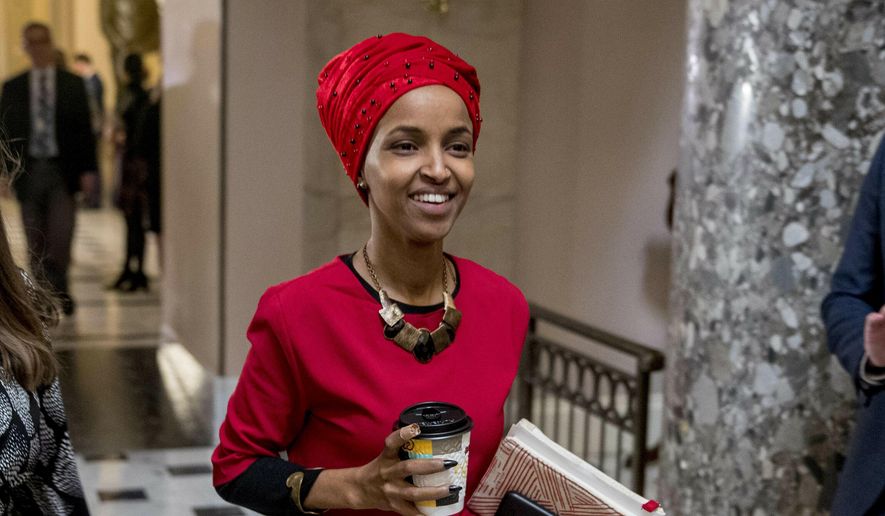 In this Jan. 16, 2019, file photo, Rep. Ilhan Omar, D-Minn., center, walks through the halls of the Capitol Building in Washington. (AP Photo/Andrew Harnik)