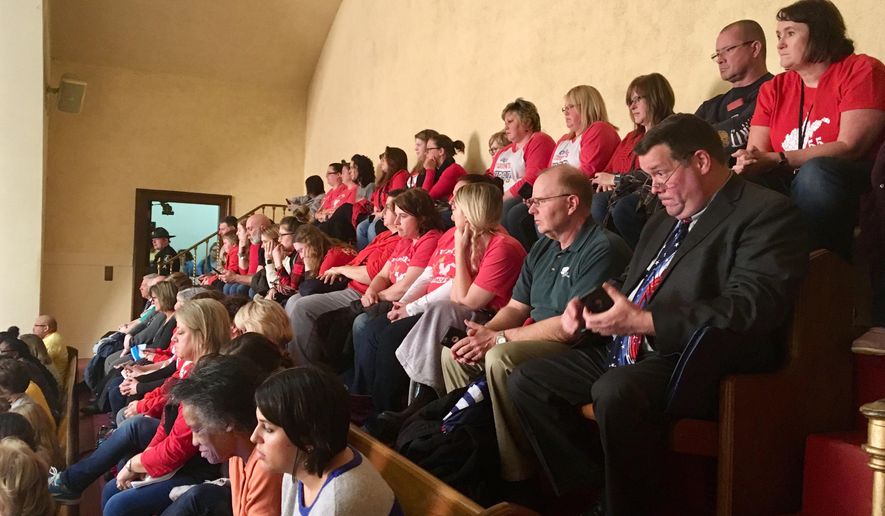 Parents, teachers and others pack an upper gallery to listen to a public hearing on complex education legislation Monday, Feb. 11, 2019, in the House of Delegates chambers in Charleston, W.Va. Dozens of speakers crammed the first of two public hearings Monday to speak against a complex education bill in West Virginia that teachers' unions claim is retaliation for a nine-day strike last year. (AP Photo/John Raby)