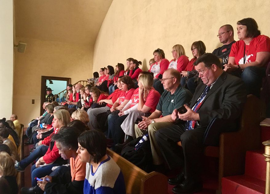 Parents, teachers and others pack an upper gallery to listen to a public hearing on complex education legislation Monday, Feb. 11, 2019, in the House of Delegates chambers in Charleston, W.Va. Dozens of speakers crammed the first of two public hearings Monday to speak against a complex education bill in West Virginia that teachers' unions claim is retaliation for a nine-day strike last year. (AP Photo/John Raby)