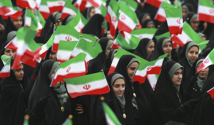 Iranians wave national flags during a ceremony celebrating the 40th anniversary of the Islamic Revolution, at the Azadi, or Freedom, Square, in Tehran, Iran, Monday, Feb. 11, 2019. On Feb. 11, 1979. Iran&#39;s military stood down after days of street battles, allowing the revolutionaries to sweep across the country, and the government of Shah Mohammad Reza Pahlavi resigned. (AP Photo/Vahid Salemi)