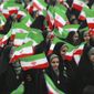 Iranians wave national flags during a ceremony celebrating the 40th anniversary of the Islamic Revolution, at the Azadi, or Freedom, Square, in Tehran, Iran, Monday, Feb. 11, 2019. On Feb. 11, 1979. Iran&#39;s military stood down after days of street battles, allowing the revolutionaries to sweep across the country, and the government of Shah Mohammad Reza Pahlavi resigned. (AP Photo/Vahid Salemi)