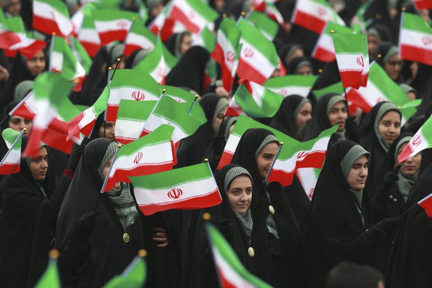 Iranians wave national flags during a ceremony celebrating the 40th anniversary of the Islamic Revolution, at the Azadi, or Freedom, Square, in Tehran, Iran, Monday, Feb. 11, 2019. On Feb. 11, 1979. Iran's military stood down after days of street battles, allowing the revolutionaries to sweep across the country, and the government of Shah Mohammad Reza Pahlavi resigned. (AP Photo/Vahid Salemi)