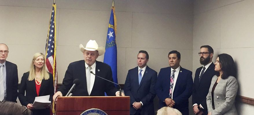 Assemblyman Jim Wheeler, Minority Floor Leader, at podium, speaks to fellow Republican lawmakers, Monday, Feb. 11, 2019, as they voice their objections to a bill requiring background checks on gun sales and transfers between private parties, at the Nevada legislature in Carson City. (AP Photo/Ryan Tarinelli)