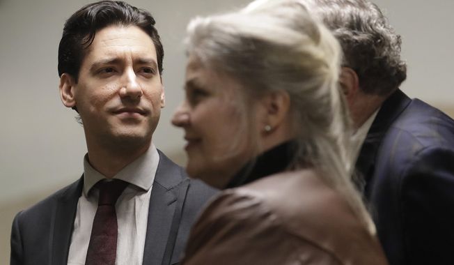 David Daleiden, left, and Sandra Merritt, foreground, wait outside of a courtroom in San Francisco, Monday, Feb. 11, 2019. Planned Parenthood has made an unusual legal demand to join California&#x27;s criminal prosecution of two anti-abortion activists charged with invasion of privacy for secretly making videos as they tried to buy fetal material from the organization.(AP Photo/Jeff Chiu)
