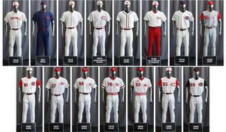 In this compilation image, the entire Cincinnati Reds baseball team uniform lineup for the 2019 season is displayed, Friday, Jan. 25, 2019, in Cincinnati. The Reds will play games in 15 sets of throwback uniforms, including navy blue and a &amp;quot;Palm Beach&amp;quot; style, during a season-long celebration of the 1869 Red Stockings who pioneered professional baseball. (AP Photo/John Minchillo)