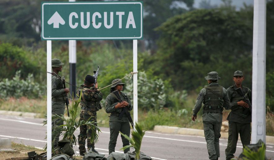 Venezuelan Bolivarian Army soldiers stand guard at the Tienditas International Bridge that links Colombia and Venezuela, near Urena, Venezuela, Friday, Feb. 8, 2019. As humanitarian aid kits were being packed into individual white bags in the city of Cucuta, just across the river from Venezuela, U.S. officials and Venezuelan opposition leaders appealed to the military to the let the aid through. (AP Photo/Fernando Llano)