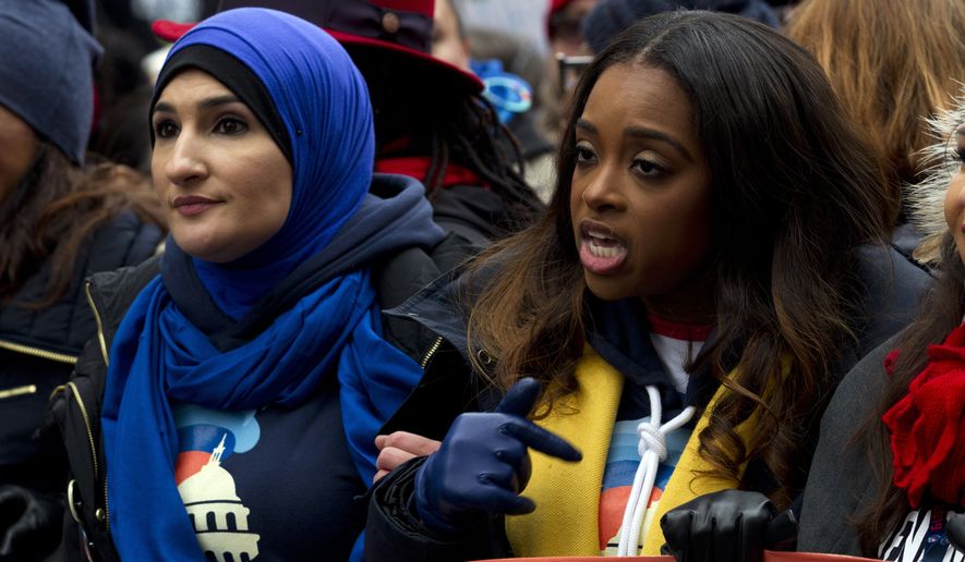 Co-presidents of the 2019 Women&#39;s March Linda Sarsour, left, and Tamika Mallory, center, march along with others demonstrators on Pennsylvania Av. during the Women&#39;s March in Washington on Saturday, Jan. 19, 2019. The Women&#39;s March returned to Washington on Saturday and found itself coping with an ideological split and an abbreviated route due to the government shutdown. (AP Photo/Jose Luis Magana)