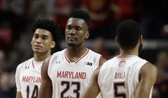Maryland forward Bruno Fernando, of Angola, (23) walks past teammates Ricky Lindo Jr., back left, and Eric Ayala in the first half of an NCAA college basketball game against Purdue, Tuesday, Feb. 12, 2019, in College Park, Md. (AP Photo/Patrick Semansky) ** FILE **
