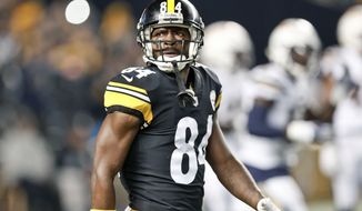 FILE - In this Dec. 2, 2018, file photo, Pittsburgh Steelers wide receiver Antonio Brown (84) plays against the Los Angeles Chargers in an NFL football game, in Pittsburgh. Antonio Brown wants out of Pittsburgh. A person with knowledge of the situation tells The Associated Press the perennial Pro Bowl wide receiver has asked the Steelers for a trade. The person spoke on the condition of anonymity because he was not permitted to publicly discuss personnel matters. Brown appeared to make his decision official in a social media post released on Instagram on Tuesday, Feb. 12, 2019. (AP Photo/Don Wright) ** FILE **