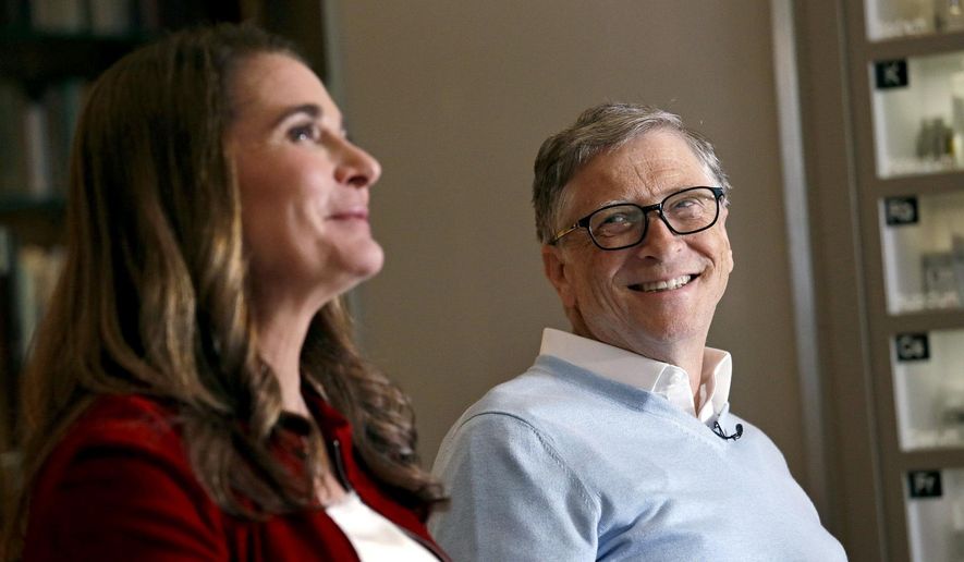 In this Feb. 1, 2019, photo, Bill Gates looks to his wife Melinda as they are interviewed in Kirkland, Wash. (AP Photo/Elaine Thompson) ** FILE **