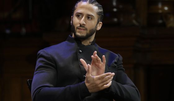 FILE - In this Oct. 11, 2018, file photo, former NFL football quarterback Colin Kaepernick applauds while seated on stage during W.E.B. Du Bois Medal ceremonies at Harvard University in Cambridge, Mass. Republican concerns that the former NFL quarterback is too controversial to honor as a black leader doomed a resolution recognizing Black History Month in the state Assembly, Tuesday, Feb. 12, 2019. The Legislature&#39;s black caucus had proposed a resolution honoring a number of black leaders, including Kaepernick, but Assembly Republicans refused to take it up. (AP Photo/Steven Senne, File)