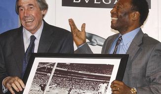 FILE - In this Thursday March 4, 2004 file photo Brazilian soccer legend Pele, right, presents former England goalkeeper Gordon Banks with a photograph showing Banks saving a header from Pele in the 1970 World Cup, at a press conference in London, to mark FIFA&#39;s 100 year anniversary. English soccer club Stoke said Tuesday Feb. 12, 2019 that World Cup-winning England goalkeeper Gordon Banks has died at 81. (AP Photo/Max Nash, File)