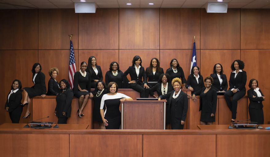 FILE - This undated file photo provided by the Harris County Democratic Party shows a group of 17 African-American women who are part of an effort dubbed the "Black Girl Magic" campaign, in Houston. Front row, leaning against the podium from left, are Maria Jackson and Ramona Franklin. Back row, from left, are Lucia Bates, Erica Hughes, Sandra Peake, Cassandra Hollemon, Germaine Tanner, Ronnisha Bowman, Linda Marie Dunson, Angela Graves-Harrington, Dedra Davis, Shannon Baldwin, Latosha Lewis Payne, Tonya Jones, Sharon Burney, Michelle Moore, Lori Chambers Gray, Toria Finch and LaShawn Williams. One of the 17 black women elected as Houston-area judges in 2018 as part of a "Black Girl Magic" campaign has died at age 57. Judge Hollemon's daughter, Brandy Hollemon, told The Associated Press on Wednesday, Feb. 13, 2019, that her mother died Monday, about a week after being diagnosed with pancreatic cancer. (Christin Mcqueen/Harris County Democratic Party via AP, File)