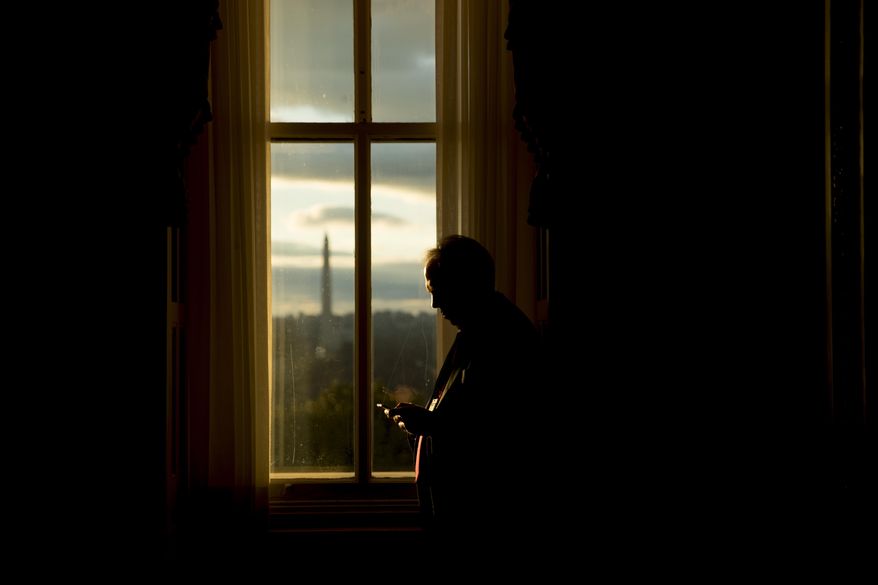 FILE- In this Jan. 24, 2019, file photo the Washington Monument is visible through a window of the U.S. Capitol building at sunset on Capitol Hill in Washington. On Wednesday, Feb. 13, the Treasury Department releases federal budget data for December. (AP Photo/Andrew Harnik, File)