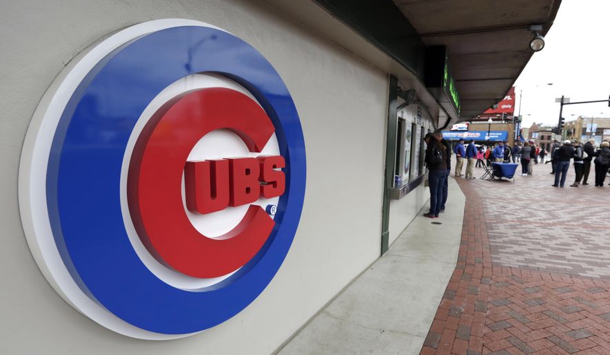 This April 15, 2013, file photo shows the Chicago Cubs logo on the exterior of Wrigley Field, in Chicago. The Chicago Cubs and Sinclair Broadcast Group are launching a regional sports network in 2020 that will be the team’s exclusive TV home. The Cubs said Wednesday, Feb. 13, 2019, the Marquee Sports Network will carry live game broadcasts and pregame and postgame coverage. (AP Photo/M. Spencer Green, File)